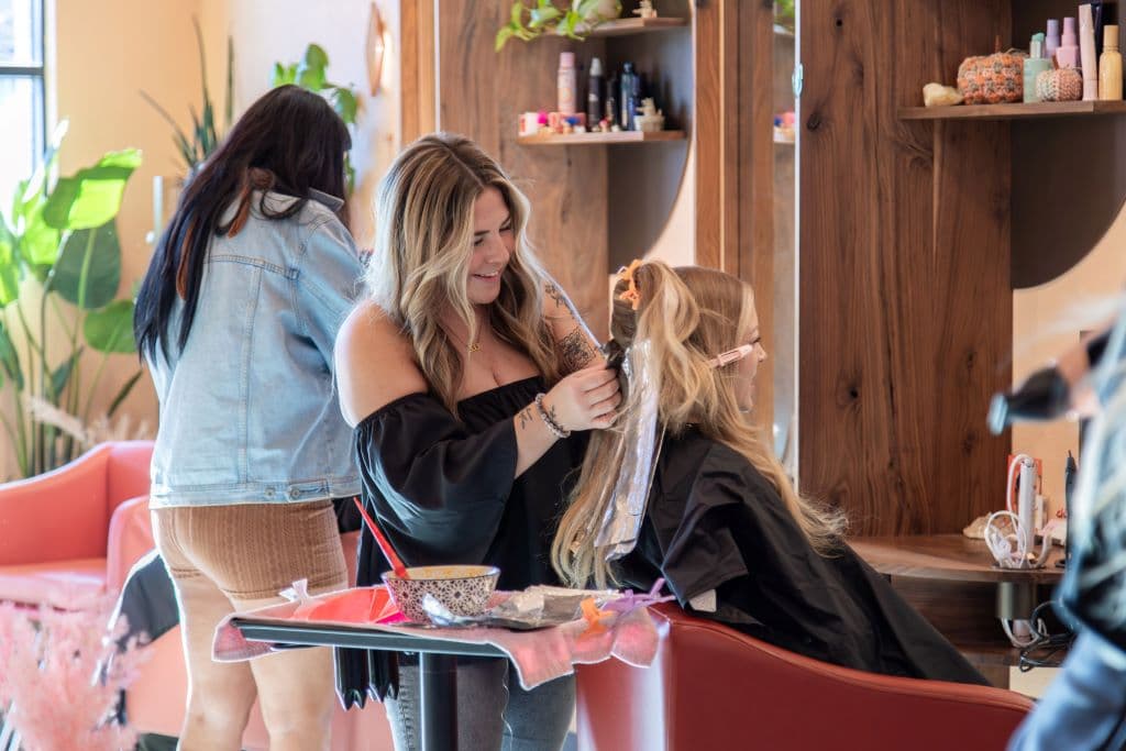 Salon professional styling client's hair