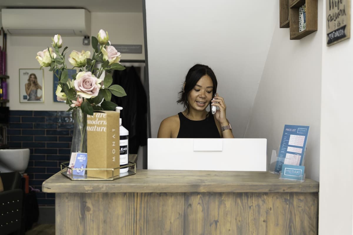 Woman answering phone to provide customer service
