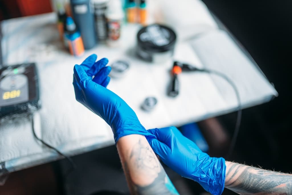 female-tattoo-artist-hands-in-blue-sterile-gloves-2024-11-26-13-15-26-utc.jpg