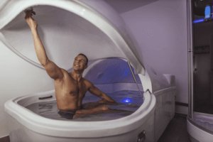 Man about to lay down in a flotation pod for a salt float