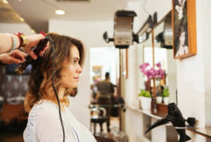 female salon client getting hair curled