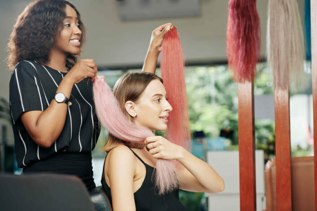hair stylist showing hair extension options to client