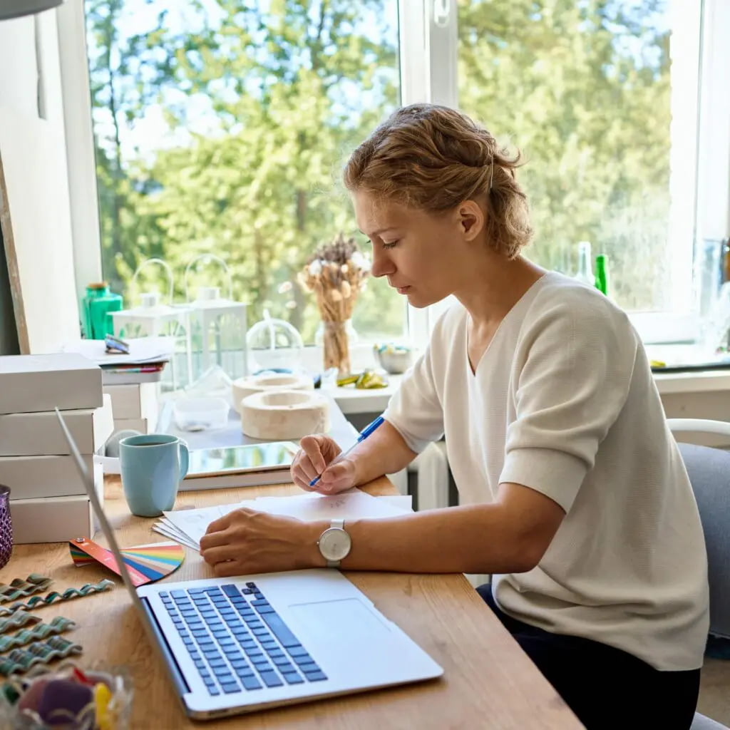 young-female-entrepreneur-designer-writing-on-pape-2021-08-29-14-24-09-utc-1-min-1024x1024.jpg.webp