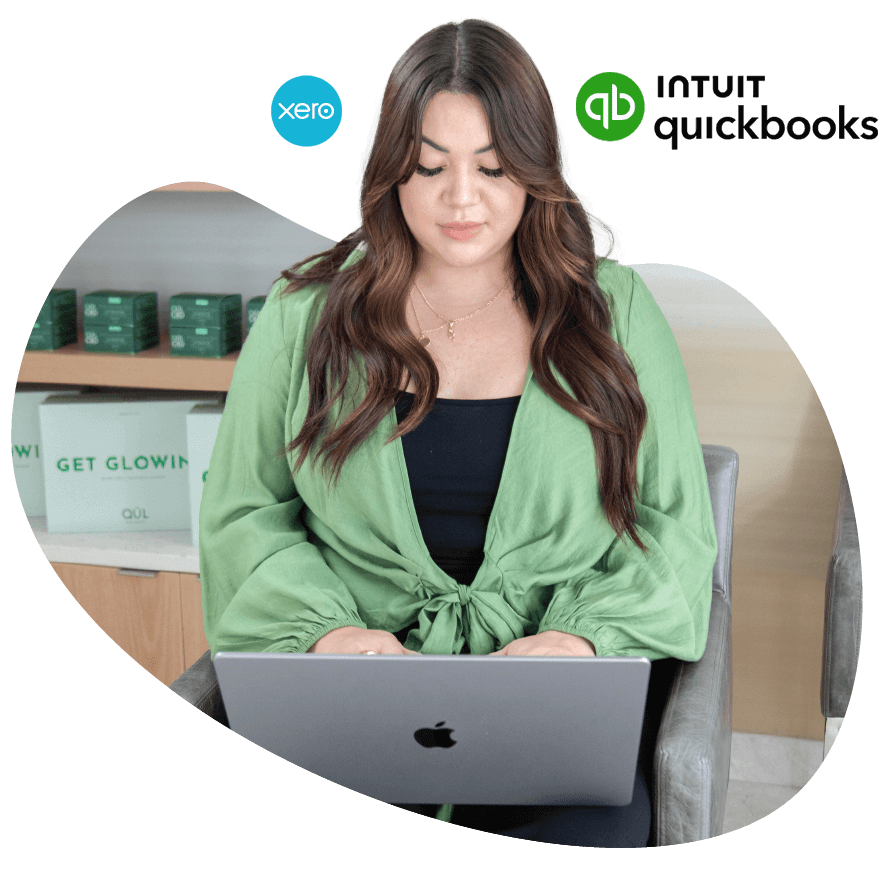 An image of a customer on a laptop viewing Vagaro's reporting in our salon, spa and fitness software.