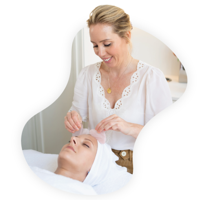 An image of skincare specialist Lisa Franklin doing a facial on a customer.